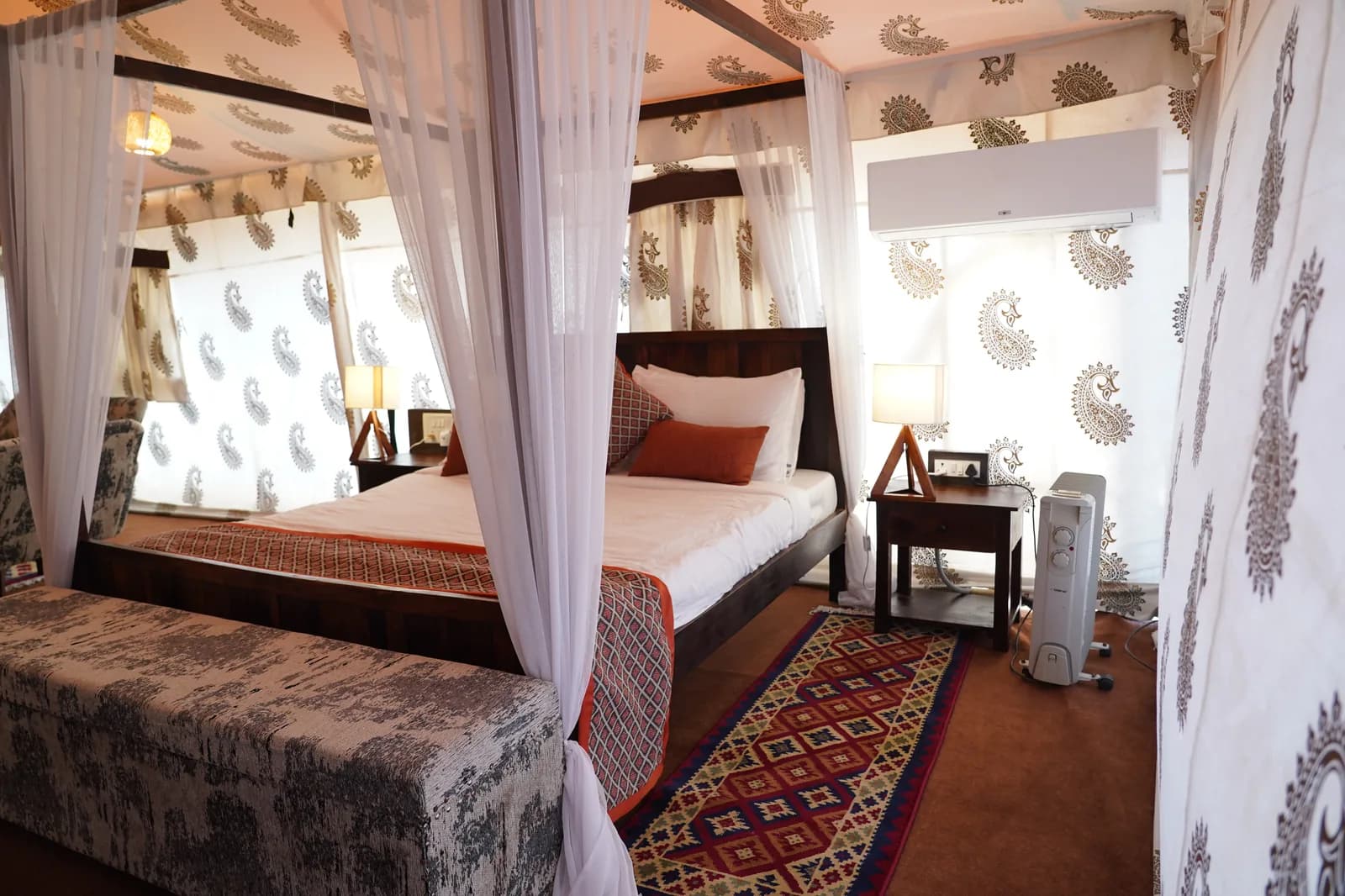 Darbari Suite royal four-poster bed with sofa lounge at Dhordo Tent City